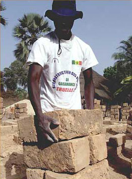 Young volunteer helping rebuild a Casamance village destroyed in the war