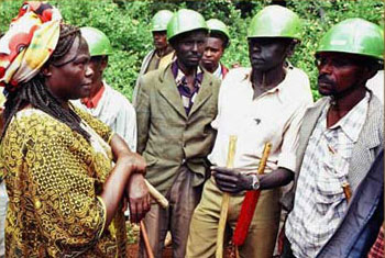 Ms. Maathai challenging government security guards during tree-planting drive in 1999