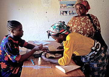 Members of a Kenyan women’s dairy cooperative receiving payments