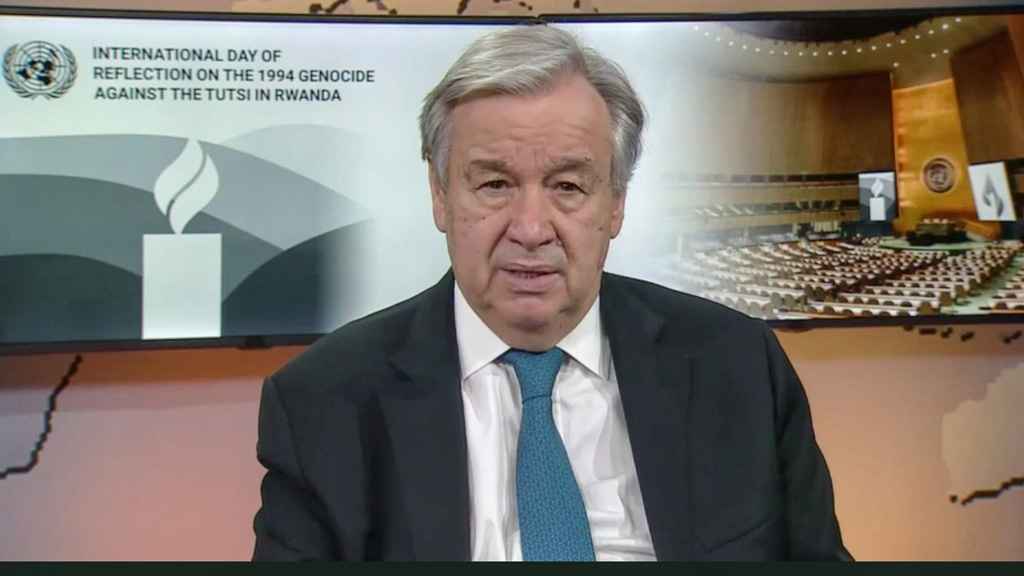 UN Secretary General speaking with a commemorative banner behind him