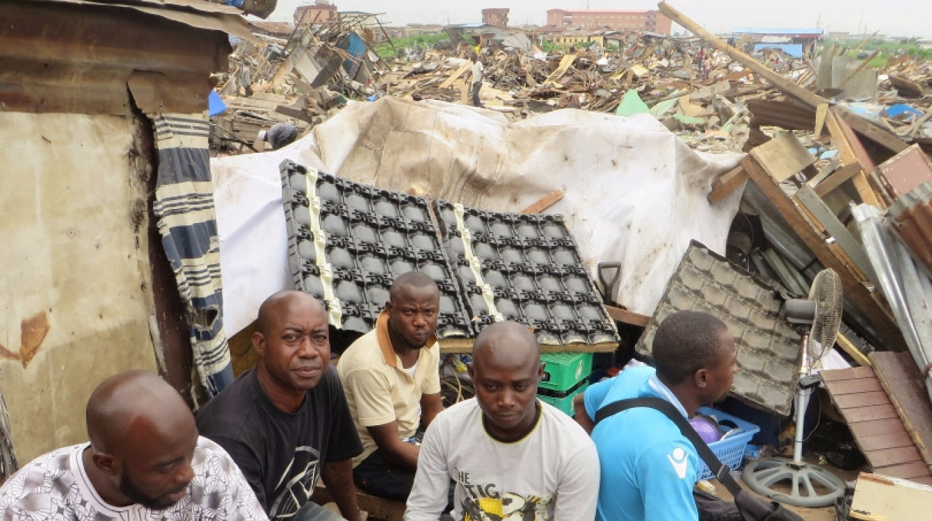 Des personnes devant les ruines de leurs maisons démolies dans le quartier de Badia, à Lagos, en octobre 2015.