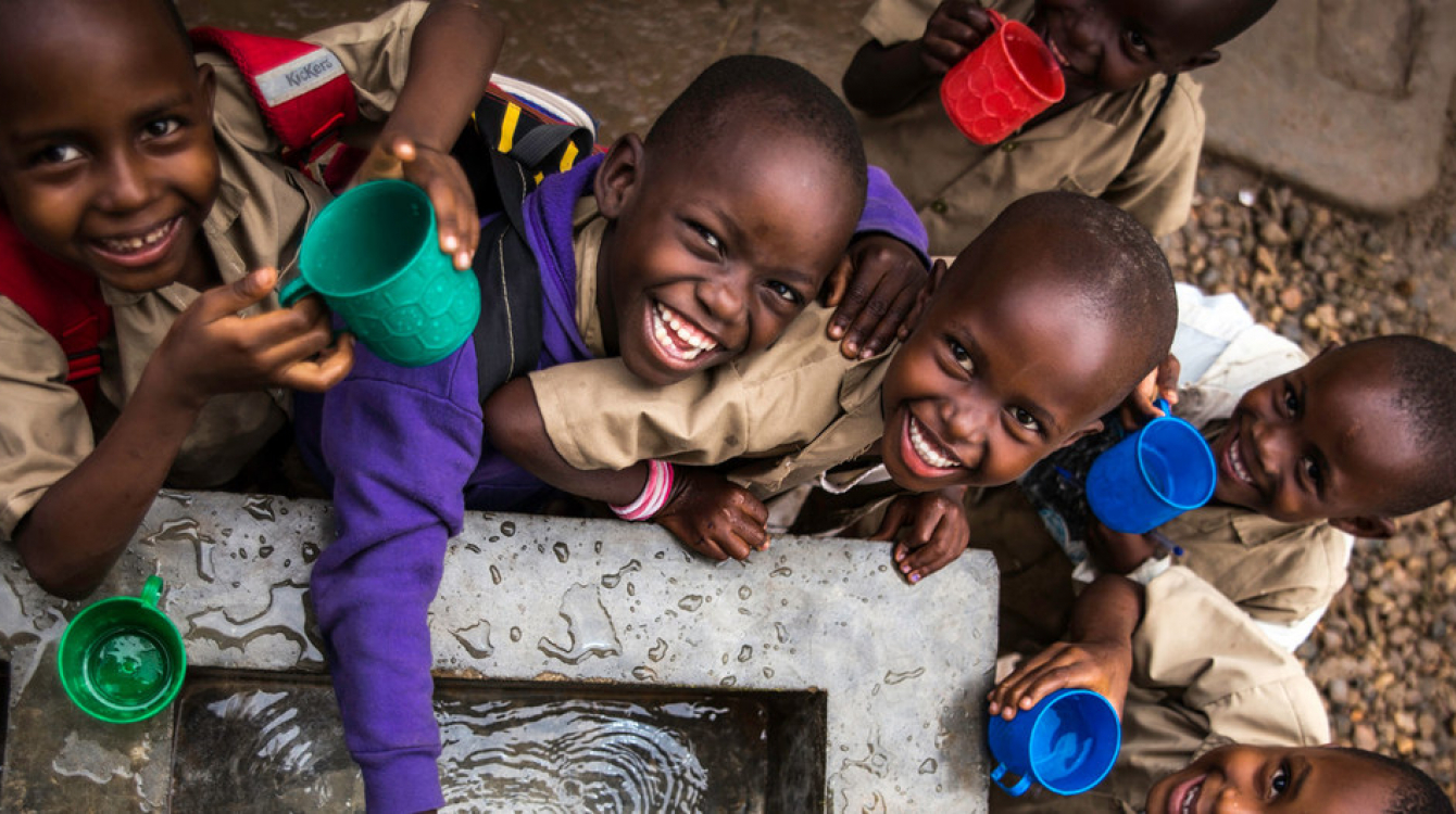 Children fill their cups at a water point built by UNICEF at Kanyosha III primary school in Bujumbura, Burundi.
