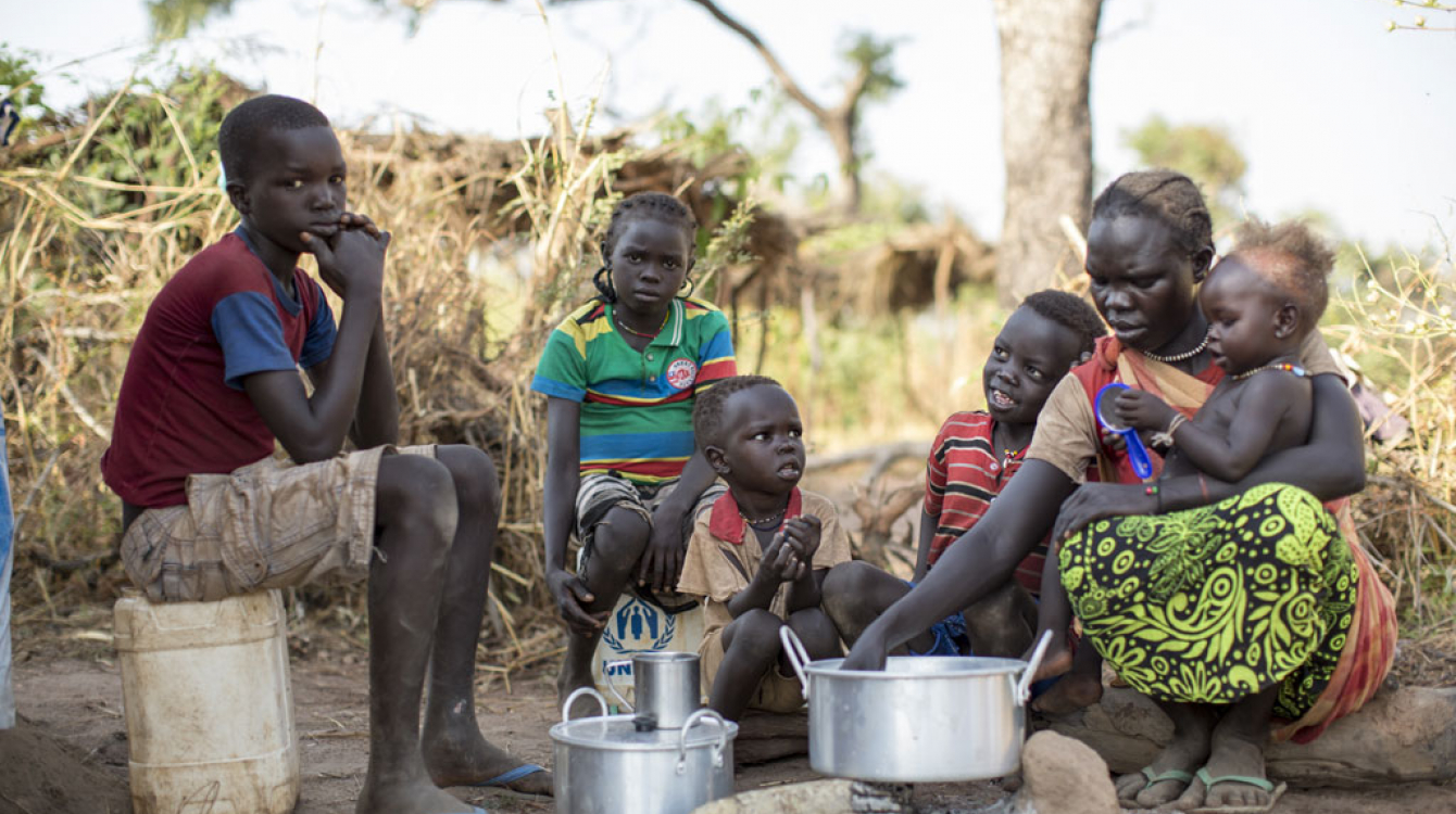 Sudanese refugee Amal Bakith cooks the first breakfast for her children a day after arriving in Ajuong Thok camp, South Sudan. During their long journey from South Kordofan, they had only rotten food to eat. Photo: UNHCR/Rocco Nur