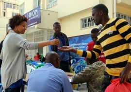 Ethiopian migrants from Tanzania receive onward transportation allowance at IOM’s Transit Centre.