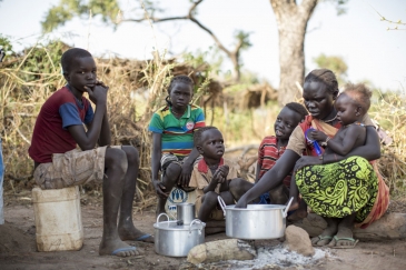 Sudanese refugee Amal Bakith cooks the first breakfast for her children a day after arriving in Ajuong Thok camp, South Sudan. During their long journey from South Kordofan, they had only rotten food to eat. Photo: UNHCR/Rocco Nuri