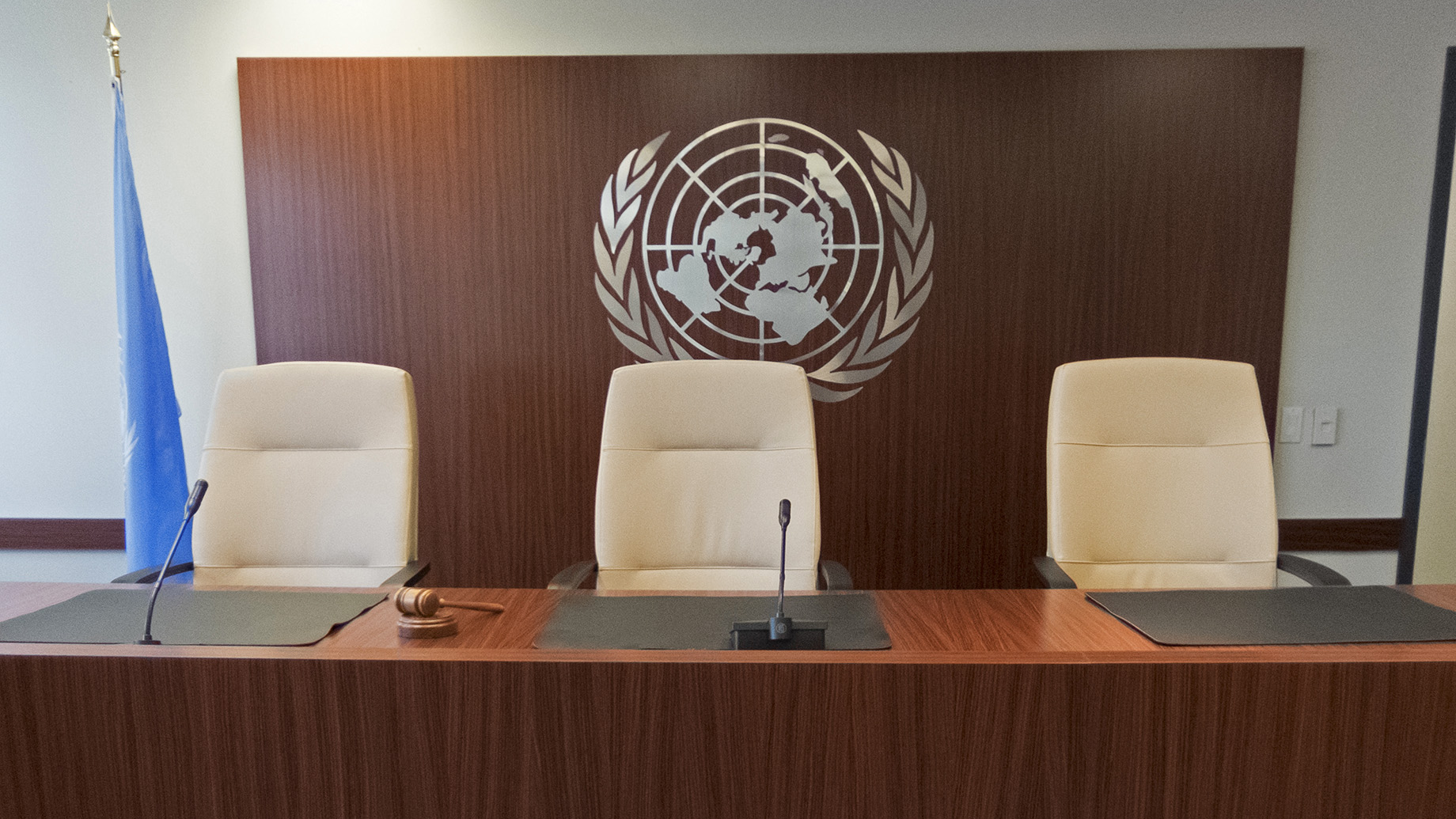 Photo of three empty judge's chairs in the UN Dispute Tribunal courtroom in New York