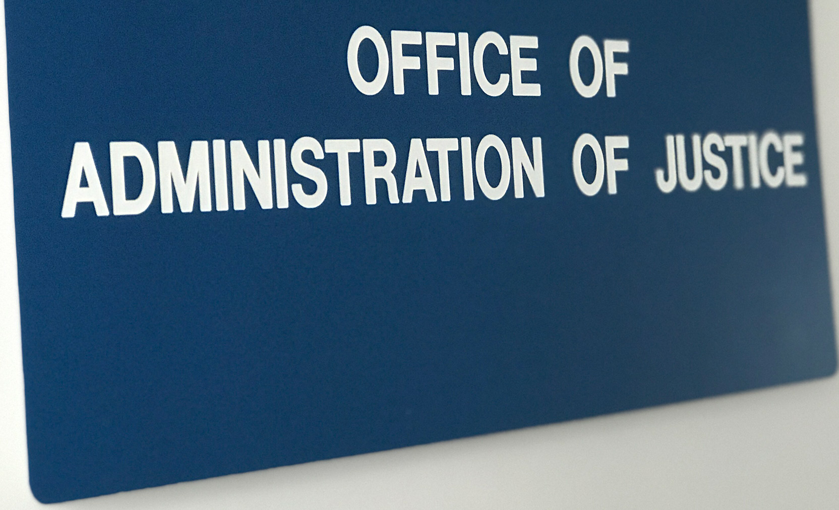 Photo of sign which reads 'Office of Administration of Justice'.