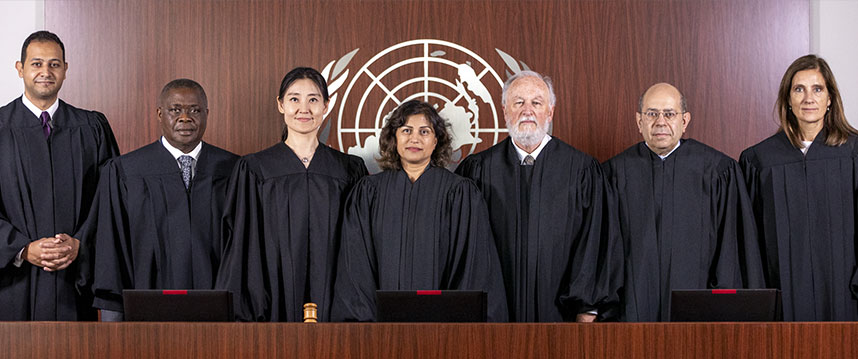 Photo of UN Appeals Tribunal judges sitting at a table in Amman, Jordan.