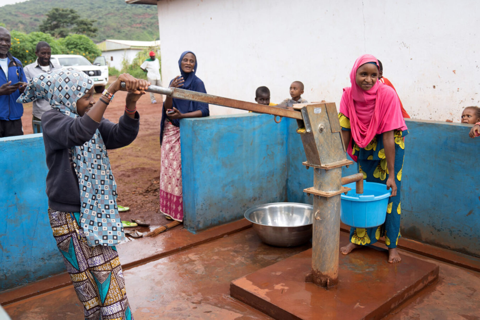 Two women pumping clean water in Cameroon.