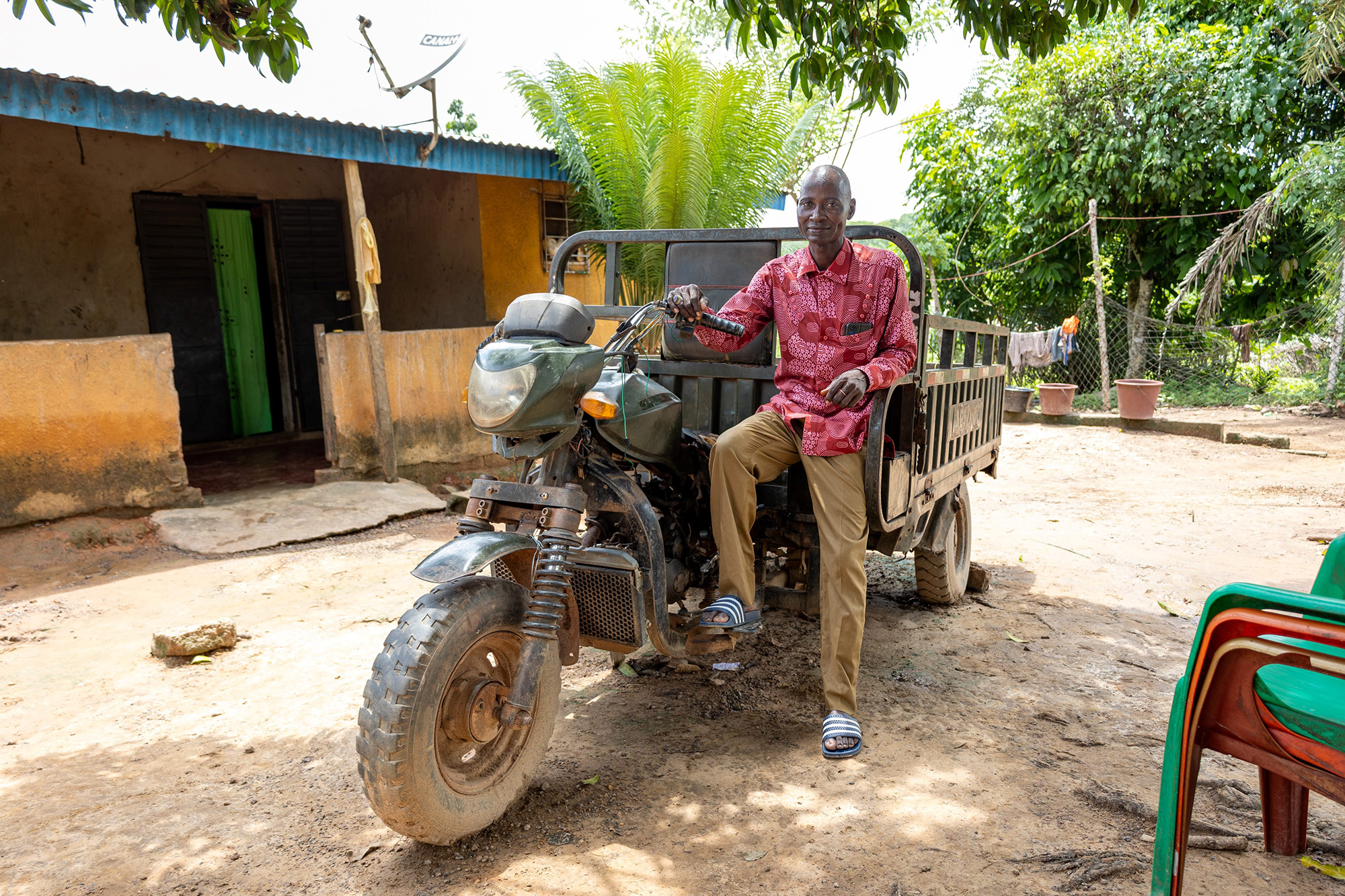 Yabao Oumarou sitting on a motorcycle cart.