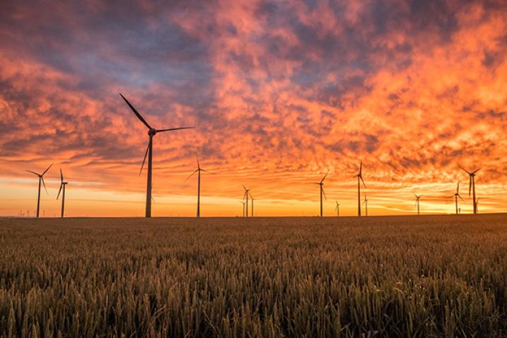 Wind turbines against the colours of a sunset.