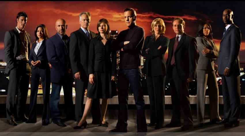Poster with the whole cast of the TV show standing in front of a dark, red background. 
