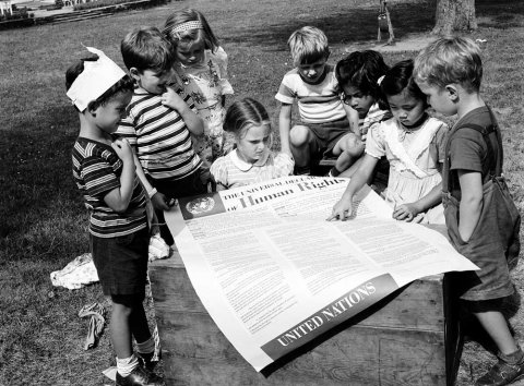 Photo courtesy of the United Nations: Students at the UN International Nursery School in New York look at a poster of the Universal Declaration of Human Rights in 1950.